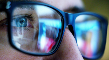closeup of woman staring at computer screen