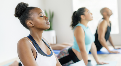 women practicing yoga in studio 