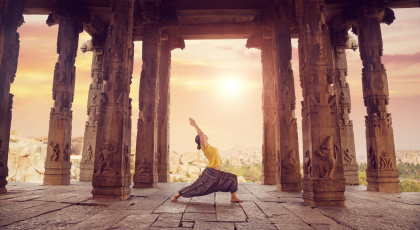 Woman Practicing Warrior 1 in a temple