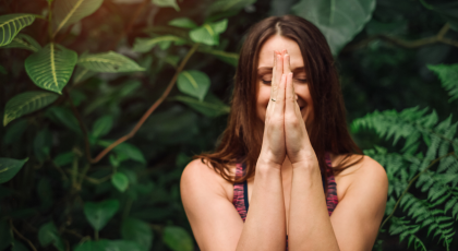 Woman with hands in prayer.