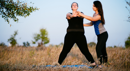 Yoga teacher teaching student with chronic pain