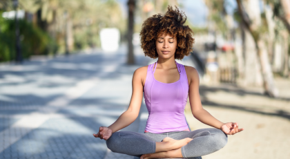 Woman practicing yoga meditation outside.