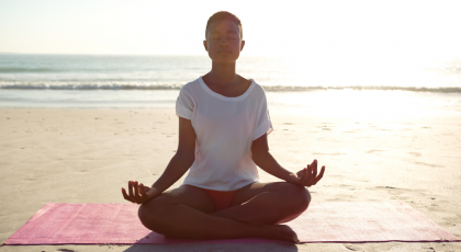Woman practicing yoga meditation outside.
