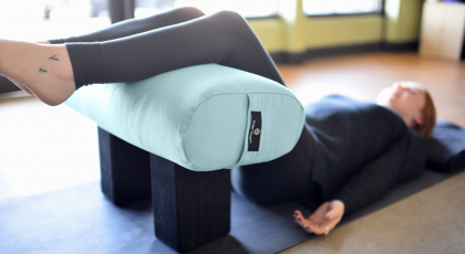 Woman practicing restorative yoga stonehenge.