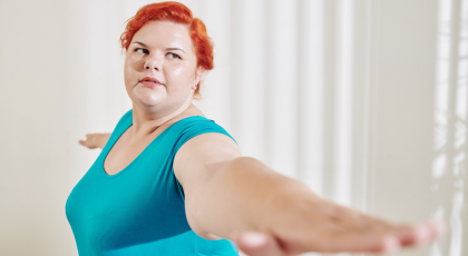 heavy-set yoga student practicing warrior II pose