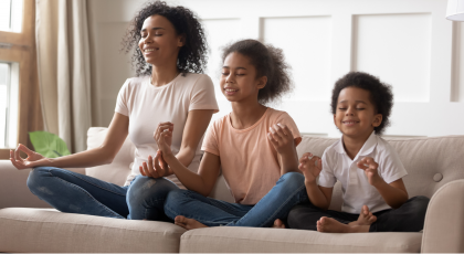 Mother and children practicing yoga in Seated Pose