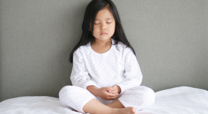 Child practicing yoga meditation ayurveda 