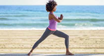 Woman practicing yoga for back pain Warrior I Pose (Virabhadrasana I)