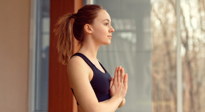 Closeup of woman practicing Tadasana mountain pose. 