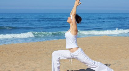 A woman in Warrior 1 pose (Virabhadrasana I), practicing yoga for inner strength