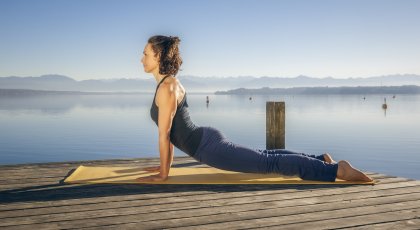 woman practicing yoga protecting her elbow complex in upward facing dog pose, Urdhva mukha svanasana