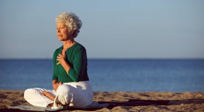 Woman practicing yoga meditation for cancer recovery benefits 