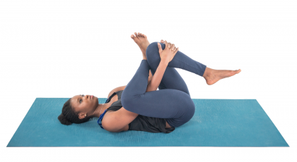 Yoga student practicing ardha matsyendrasana seated spinal twist.
