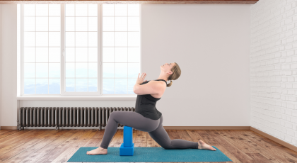 Woman practicing yoga quadriceps Low Lunge Pose (Anjaneyasana)