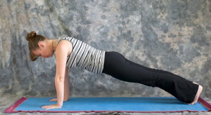woman in plank pose (Phalakasana) to improve posture