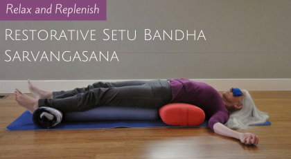 Woman practicing Restorative Setu Bandha Sarvangasana (Bridge Pose)
