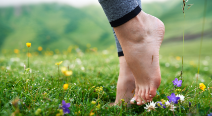 barefoot feet do yoga in field to develop brain