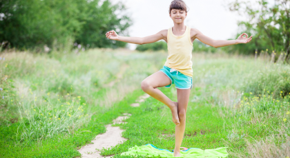 Child practicing yoga Tree Pose (Vrksasana)