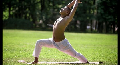 Man practicing yoga in Warrior I Pose (Virabhadrasana I)