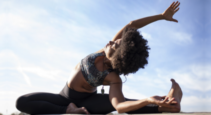 Woman practicing yoga for back pain side stretch
