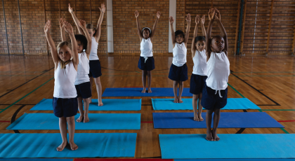 Kid's yoga class in Mountain Pose (Tadasana)