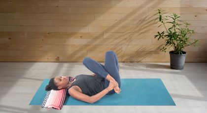 yoga woman practicing reclined cow face pose, gomukhasana 
