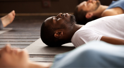 yoga men doing savasana