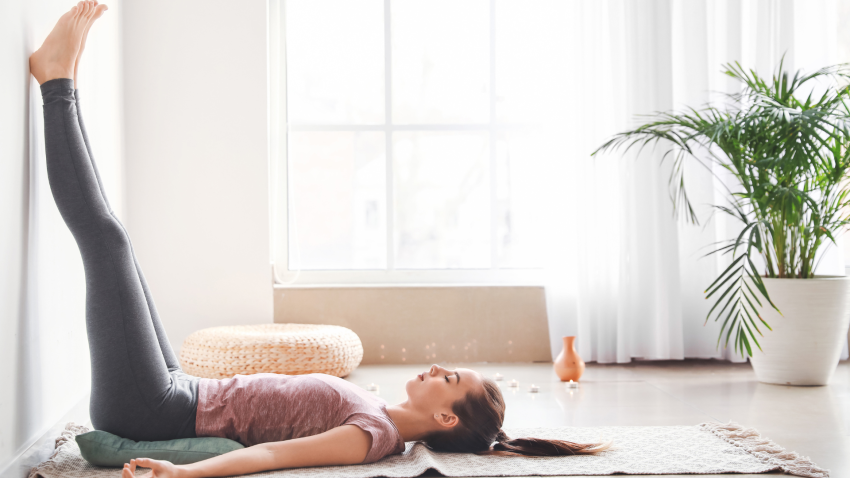 Beautiful young woman practicing yoga at home. Concept of finding contentment in the simple things i
