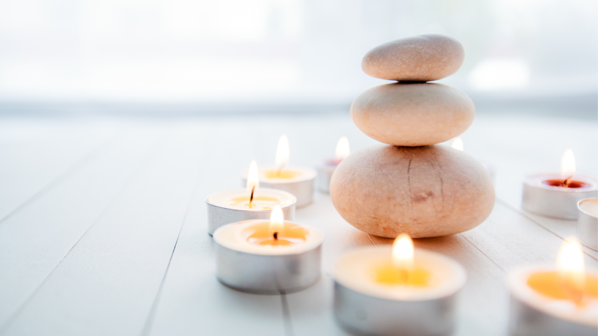 Zen Meditation Harmony, Spa Lifestyle, balanced stack of stones with aromatic candles on wooden whit
