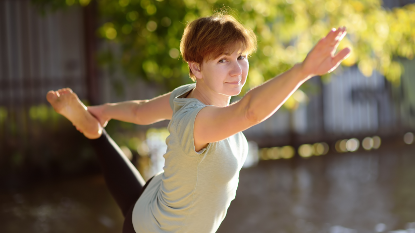 how to increase your mood with yoga Older beginner yoga student practicing yoga outside to increase serotonin