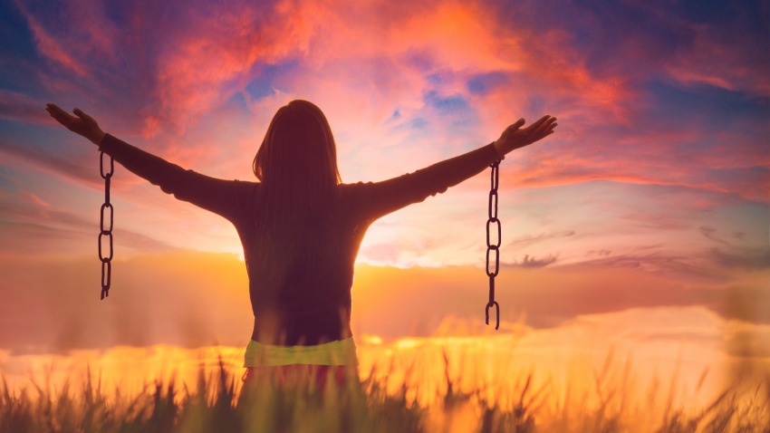 Woman holdng a broken chain representing the celebration of letting go of resentment