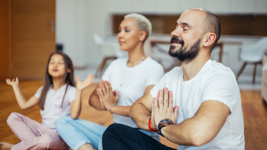 How to practice gratitude for family and the holidays cultivating aparigraha. Family togetherness and gratitude hands are in Anjali Mudra Prayer Position cultivating aparigraha