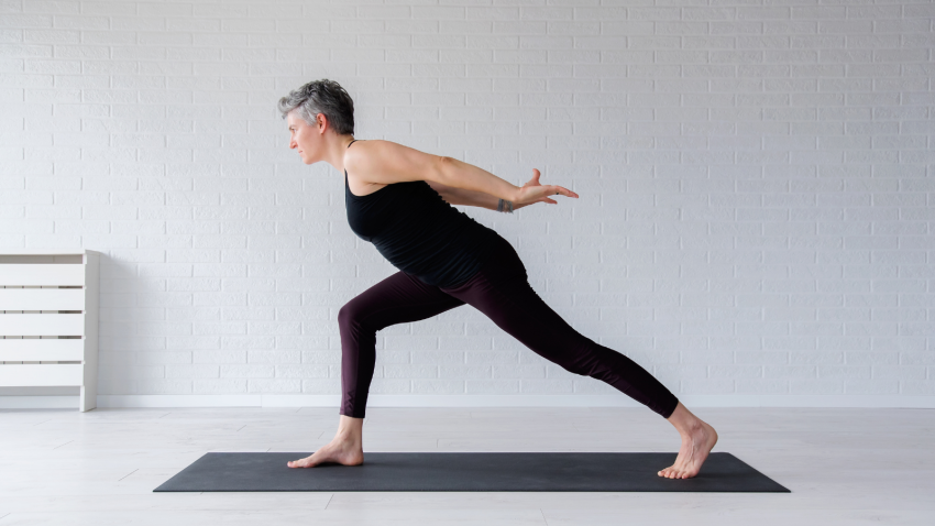 How to practice Warrior 1 for strengthening and for heart and brain health. Mature woman practicing a Warrior 1 variation.