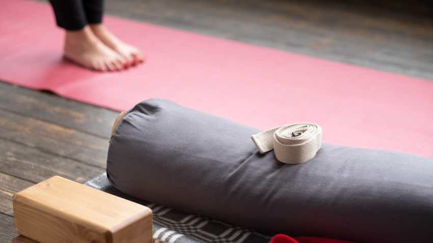 How to practice yoga that takes good care of your feet Female yoga student legs on yoga mat. Yoga props for Iyengar lesson