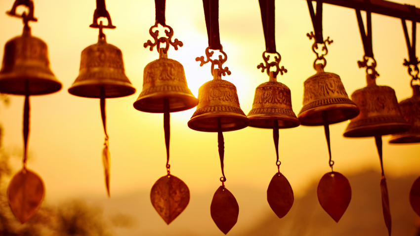 Nepali Bells symbolic here of Sahasrara (Crown Chakra) Nepali traditional Bells over the sun at sunset
