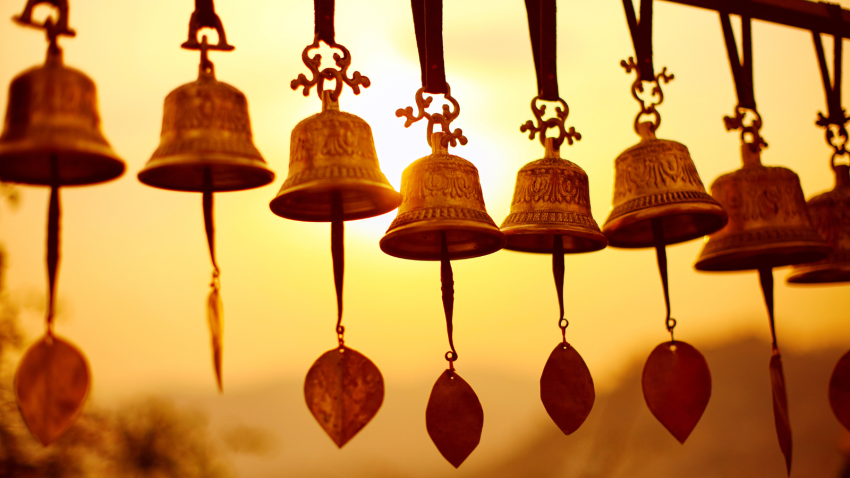 Nepali traditional Bells over the sun at sunset
