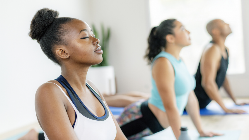 women practicing yoga in studio women practicing yoga in studio