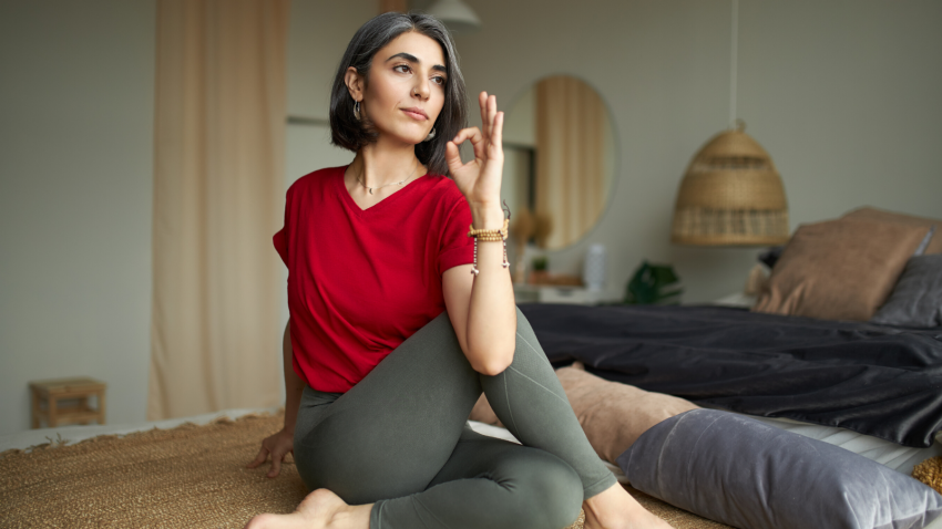 Female yoga student practicing seated twist marichyasana Female yoga student practicing seated twist marichyasana