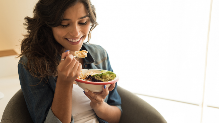 Woman eating healthy vegetarian meal. Woman eating healthy vegetarian meal.