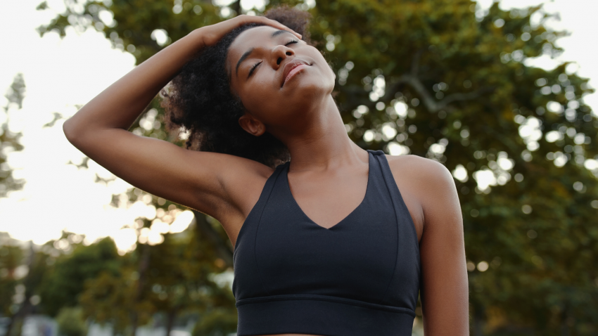Woman practicing yoga for neck health with a neck stretch