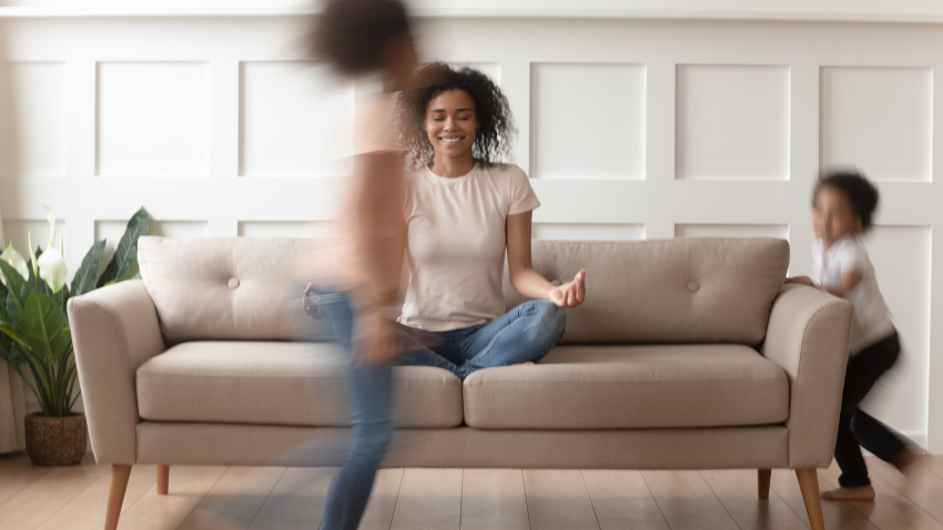 Woman practicing yoga meditation at home with kids. Woman practicing yoga meditation at home with kids.