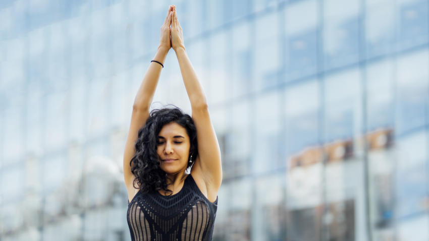 Woman practicing yoga outside hands in prayer. Woman practicing yoga outside hands in prayer.