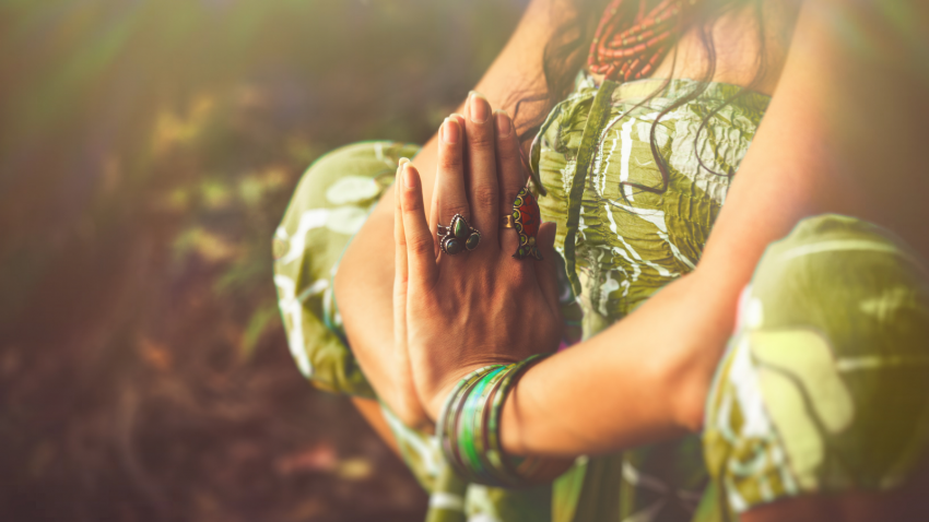 Woman practicing prayer or meditation, energy anatomy vs. physical anatomy, the 7 chakras woman in prayer or meditation, energy anatomy, chakras, mudras