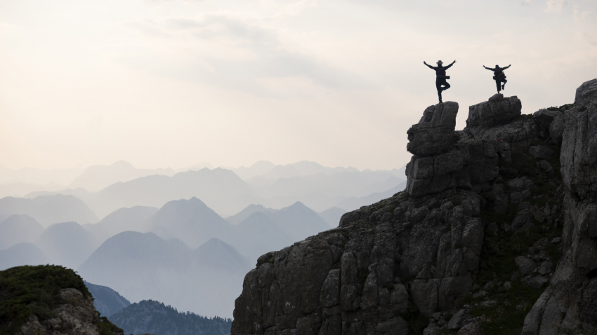 People practicing tree pose (vriksasana), being present, mindful living, scenic mountain top People practicing tree pose (vriksasana) at scenic mountain top