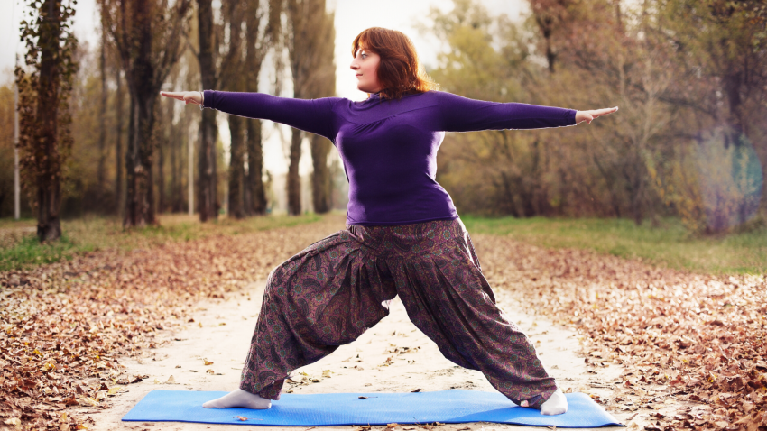 Woman practicing yoga for pain care Warrior II Pose (Virabhadrasana II)