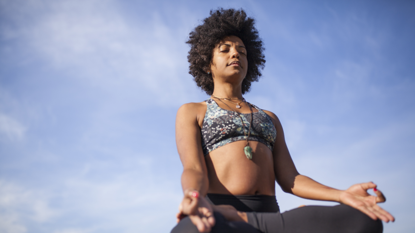 yoga woman cultivating gratitude in meditation pose yoga woman cultivating gratitude in meditation pose