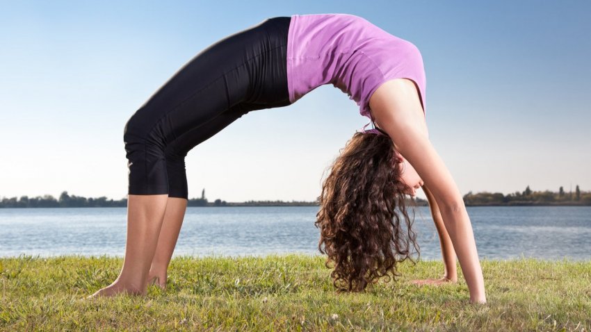 woman doing Urdhva Dhanurasana or Upward Bow Pose, backbend
