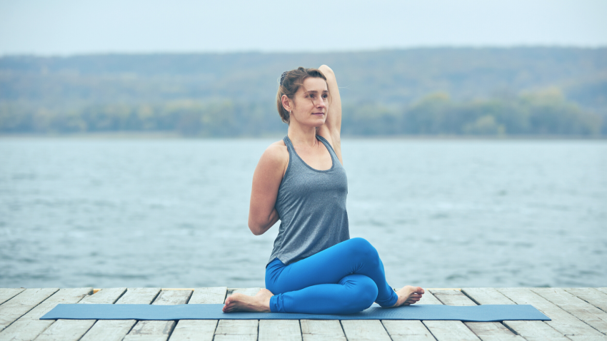 woman practicing gomukhasana woman practicing gomukhasana