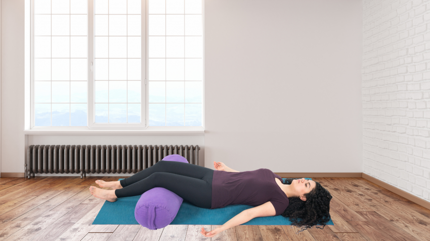 Woman practicing yoga for jaw discomfort Corpse Pose (Savasana)