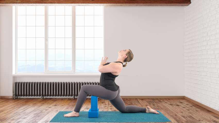 Woman practicing yoga quadriceps Low Lunge Pose (Anjaneyasana)